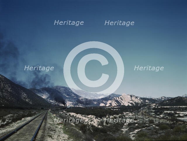 Freight train going up Cajon Pass through the San Bernardino Mountains, Cajon, Calif., 1943. Creator: Jack Delano.