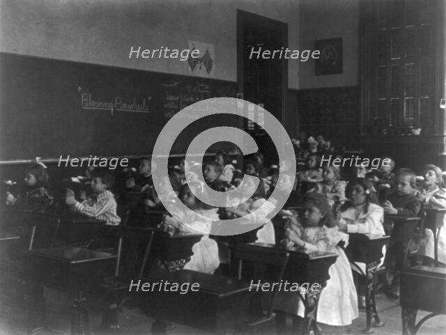 Children in a classroom blowing pinwheels in a Washington, D.C., grade school, (1899?). Creator: Frances Benjamin Johnston.
