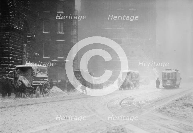 Horse-drawn wagons on snowy street, NY snow storm, 1910. Creator: Bain News Service.