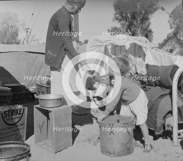 Drought refugees in migratory agricultural workers' camp, California, 1937. Creator: Dorothea Lange.