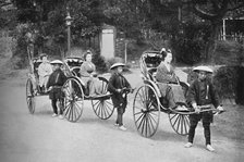 Japanese ladies in rickshaws drawn by coolies, 1902. Artist: Unknown.