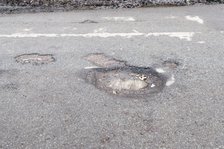 Pot holes in road surface 2017. Creator: Unknown.