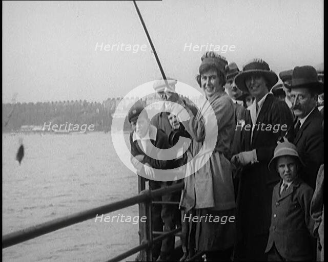 Female Civilian Fishing from a Pier Watched by a Small Crowd, 1920. Creator: British Pathe Ltd.