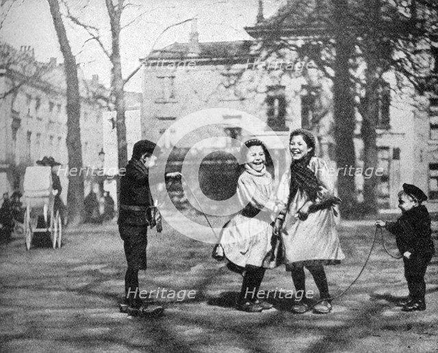 Children skipping in the Grand Place, Bruges, Belgium, 1922.Artist: FC Davis