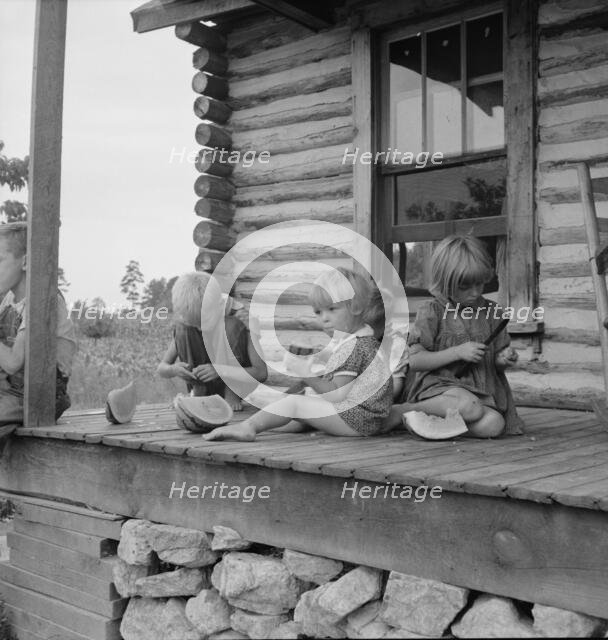 Millworker's children eating watermelon on porch..., Person County, North Carolina, 1939. Creator: Dorothea Lange.