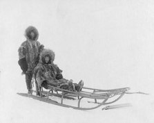 Couple on dog sled, between c1900 and 1927. Creator: Lomen Brothers.