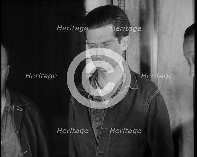 A group of Male Americans Civilians Wearing Prisoners Outfits Being Escorted Into a Room..., 1930. Creator: British Pathe Ltd.