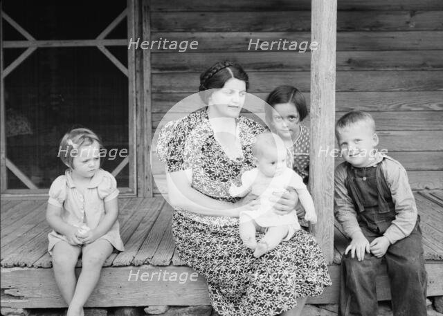 Wife and children of tobacco sharecropper on front porch, Person County, North Carolina, 1939. Creator: Dorothea Lange.