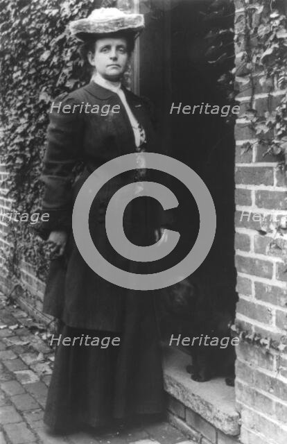 Frances Benjamin Johnston, in doorway with cocker spaniel, n.d.. Creator: Frances Benjamin Johnston.