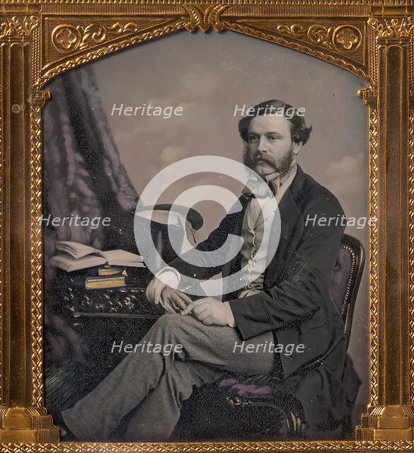 Man Seated in Front of Cloud Backdrop, Books and Top Hat on Table, 1850s. Creator: Unknown.