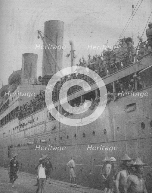 'At Singapore Indian troops arrive to take part in the defence of the great fortress-port.', 1941.  Artist: Unknown.