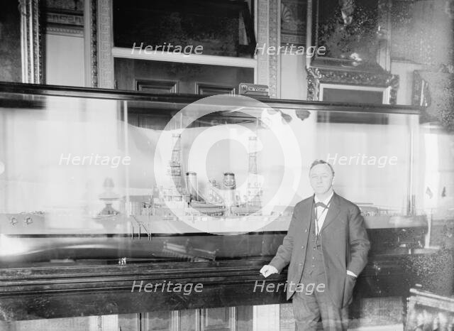 Daniels, Josephus, Secretary of The Navy, 1913-1921. with Model of U.S.S. New York, 1914. Creator: Harris & Ewing.