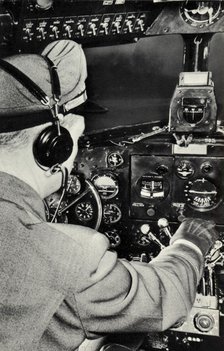 Pilot in the cockpit of a Douglas DC-3 aeroplane, 1940. Artist: Unknown