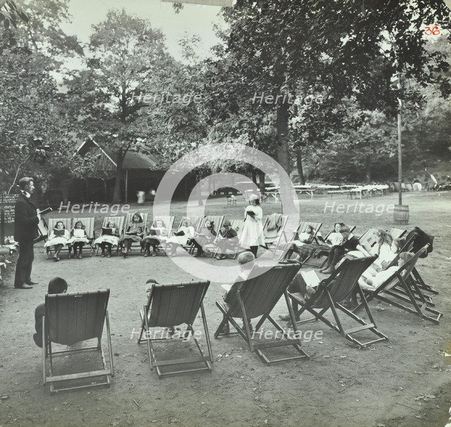 Reading lesson outside, Bostall Woods Open Air School, London, 1907. Artist: Unknown.