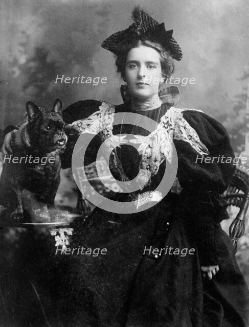 Natalie Barney seated with dog, 1910. Creator: Bain News Service.