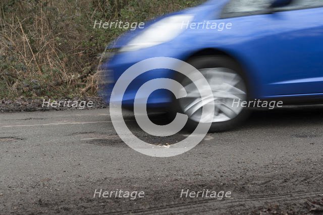 Pot holes in road surface 2017. Creator: Unknown.