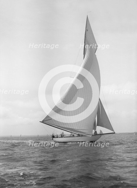 The 15-metre cutter 'Ostara' sailing downwind, 1911. Creator: Kirk & Sons of Cowes.