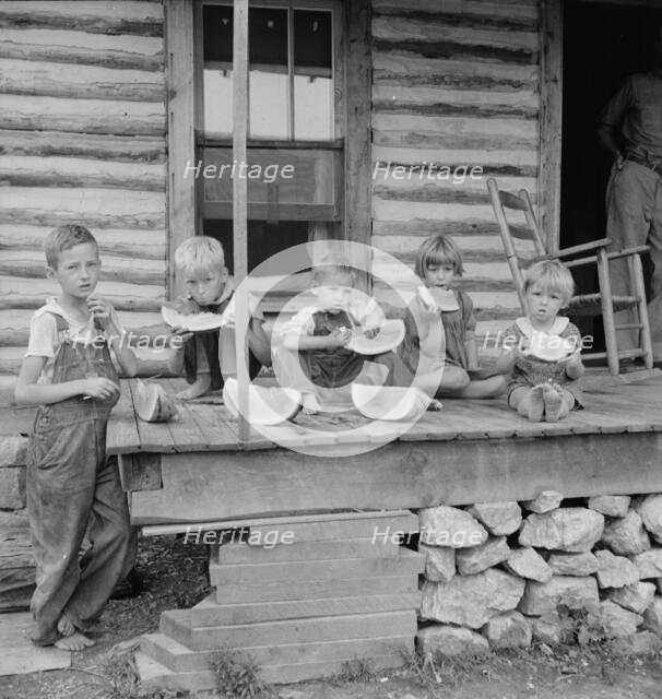 Millworker's children eating watermelon on porch of rented house, Person County, N Carolina, 1939. Creator: Dorothea Lange.