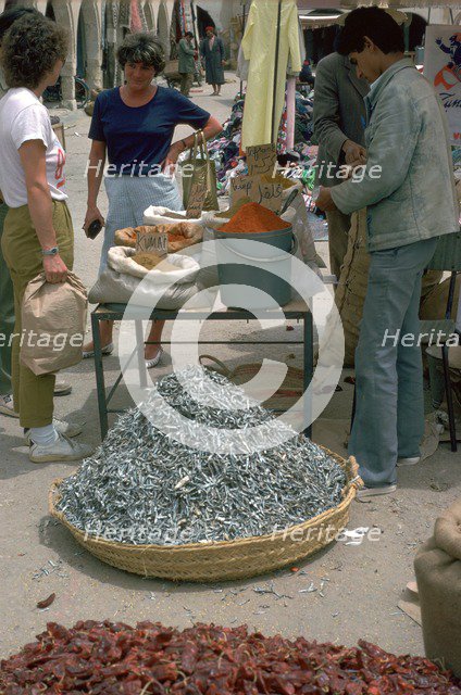 Selling spices and fish in Gabes market. Artist: Unknown