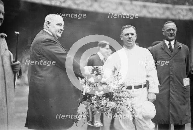 Edward McCall presents a silver basket of flowers to New York Giants manager John McGraw..., 1913. Creator: Bain News Service.