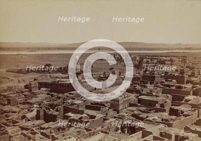 Village of Edfu, View Taken from the Pylon of the Temple, late 19th century. Creator: Henri Bechard.