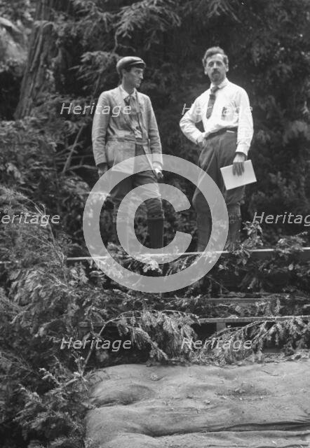 Sterling, George, and Porter Garnett, standing...at the Bohemian Grove, Sonoma, Ca., c1906-1911. Creator: Arnold Genthe.