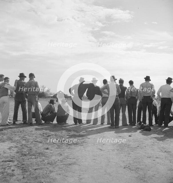 Watching ball game, Shafter migrant camp, California, 1938. Creator: Dorothea Lange.