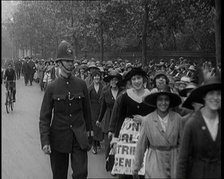 Striking Tea Shop Ladies Marching Down the Road, Flanked by Police, 1920. Creator: British Pathe Ltd.