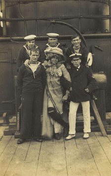 Six sailors, one in drag, pose for a group portrait on the deck of HMS St...(between 1910 and 1919?) Creator: Unknown.