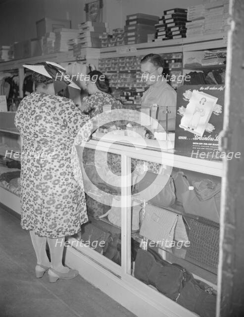 Shopper in a store at 7th Street and Florida Avenue, N.W., Washington, D.C., 1942. Creator: Gordon Parks.