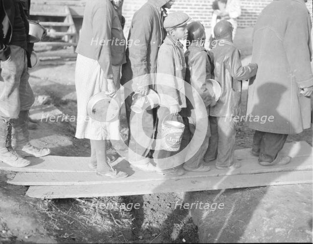 Negroes waiting for food in the Forrest City, Arkansas, refugee camp, 1937. Creator: Walker Evans.