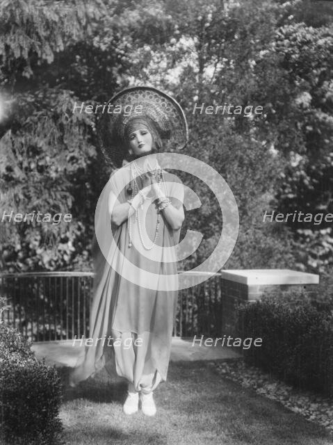 Person wearing a mask made by W.T. Benda, 1925 Sept. 20. Creator: Arnold Genthe.