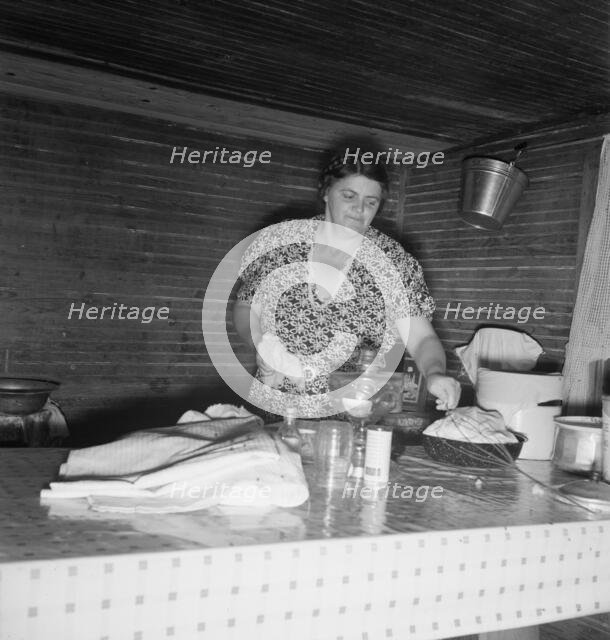 Tobacco sharecropper's wife cleaning up table after washing..., Person County, North Carolina, 1939. Creator: Dorothea Lange.