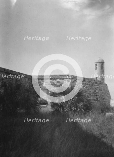 Walls and round tower by the water, Castillo de San Marcos, St. Augustine, Florida, c1920-c1926. Creator: Arnold Genthe.