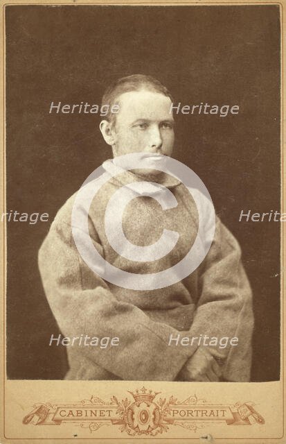 Half-length portrait of a man in convict coat, seated, facing right, between 1880 and 1886. Creator: Unknown.