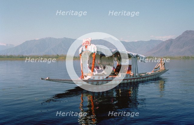Shikara (traditional wooden boat) on Dal Lake, Srinagar, Kashmir, India.