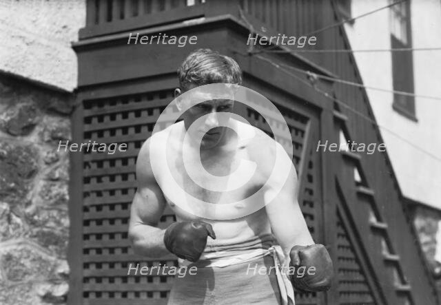 Bombardier Billy Wells, English boxer, preparing in Rye, N.Y., for fight with Al Panzer, 1912. Creator: Bain News Service.