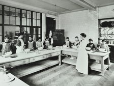 Student teacher in a cookery lesson, Battersea Polytechnic, London, 1907. Artist: Unknown.