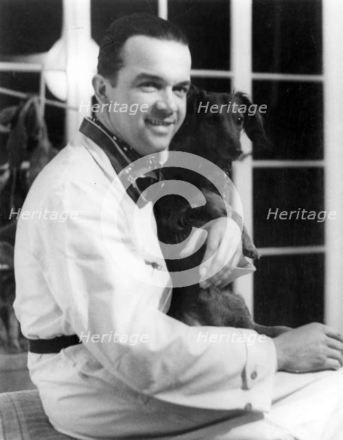 Racing driver Rudolph Caracciola with his pet dog. Creator: Unknown.