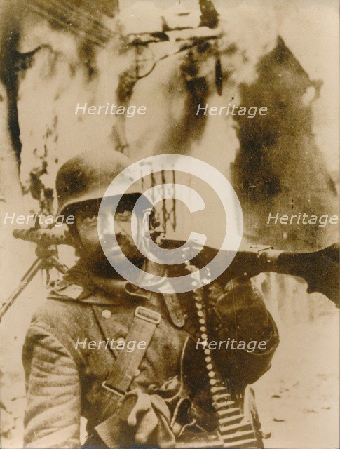 A German soldier standing in a burning Russian village. Artist: Unknown