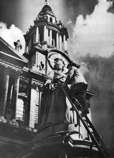 Cleaning the statue of Queen Anne as part of King George V's silver jubilee celebrations, 1935. Artist: Unknown