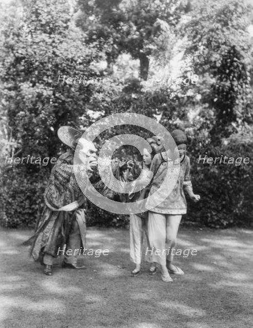 People wearing masks made by W.T. Benda, 1925 Sept. 20. Creator: Arnold Genthe.