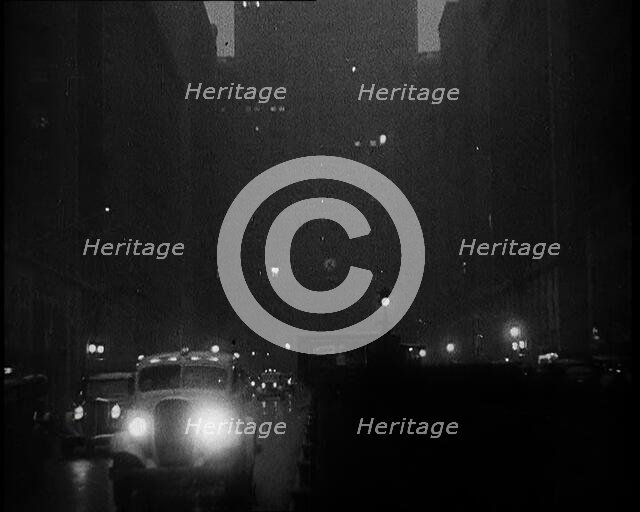 A Car Driving Towards the Camera With Very Bright Head Lights On the Streets of New York..., 1932. Creator: British Pathe Ltd.