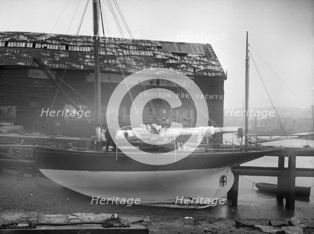 The yawl 'Banzai' dried out at boatyard mooring, 1912. Creator: Kirk & Sons of Cowes.