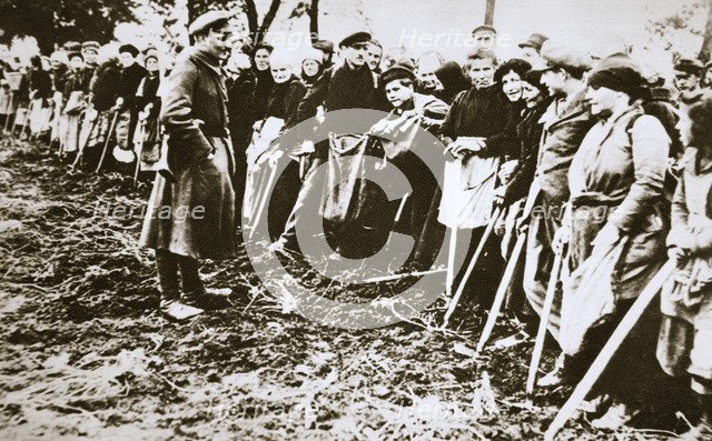Townsfolk wait to scour the fields for potatoes left by farmers, Germany, World War I, c1914-c1918. Artist: Unknown