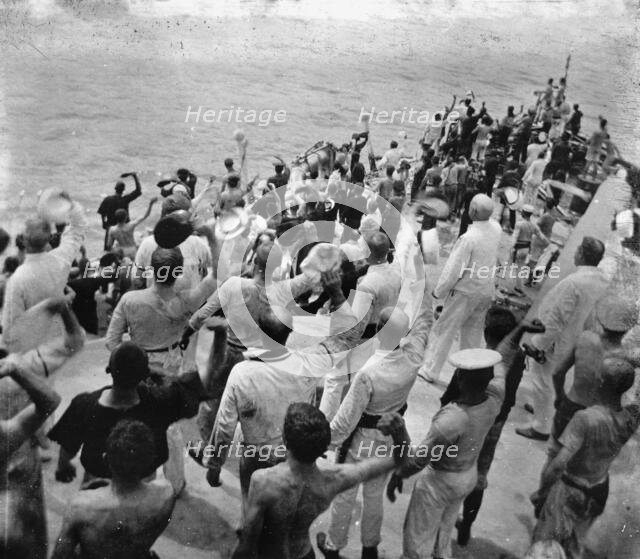 U.S.S. Oregon, cheering the hauling down of the Colon's colors, Battle of Santiago, 1899 July. Creator: Edward H Hart.