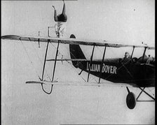 Lilian Boyer Performing Acrobatic Feats from a Flying Biplane, 1922. Creator: British Pathe Ltd.