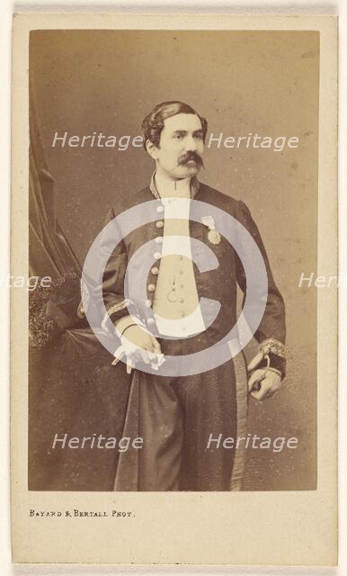 Unidentified man with moustache standing, wearing a medal on his lapel, about 1861. Creator: Bayard & Bertall.