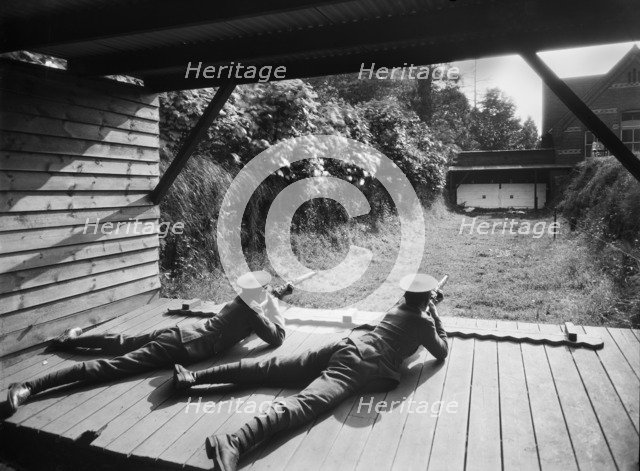 Cadets in the Officer Training Corps using the rifle range, Reading School, Berkshire, 1920-1939. Artist: Marshall Keene and Company.