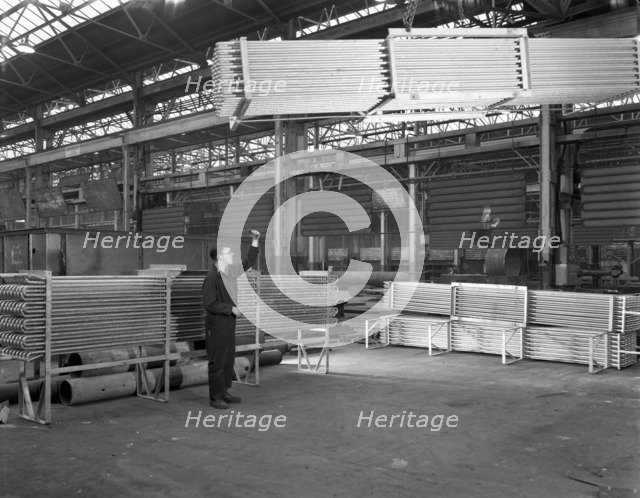 Lowering galvanised heat exchangers, Edgar Allen Steel Co, Sheffield, South Yorkshire, 1964. Artist: Michael Walters